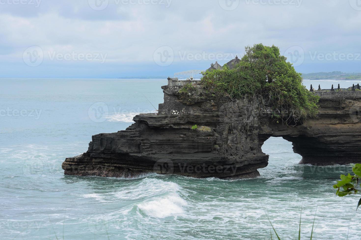 Batu Bolong is the traditional Balinese temple located on small rocky , Bali , Indonesia photo
