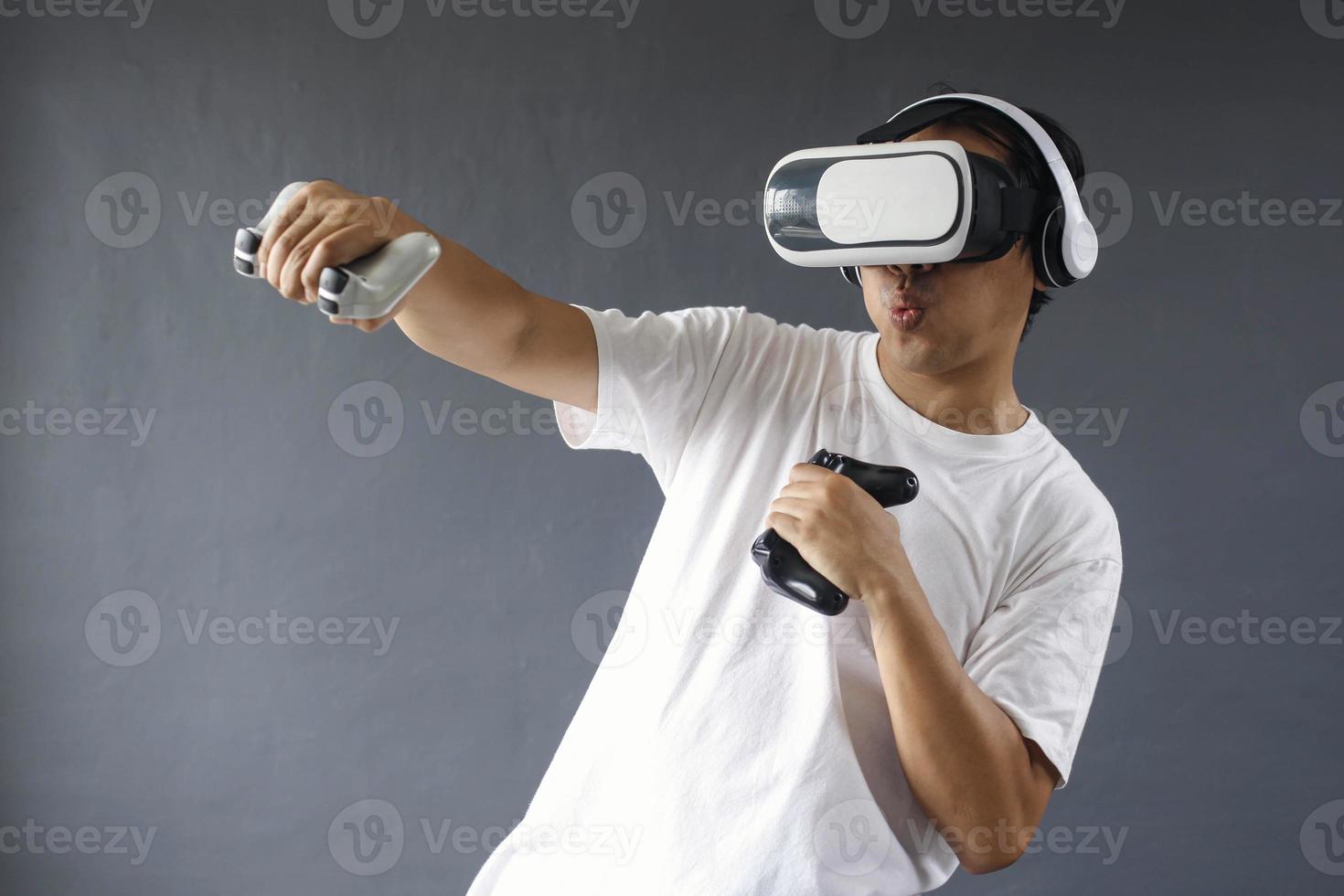 Young man is boxing and using VR to work out and play the game. photo
