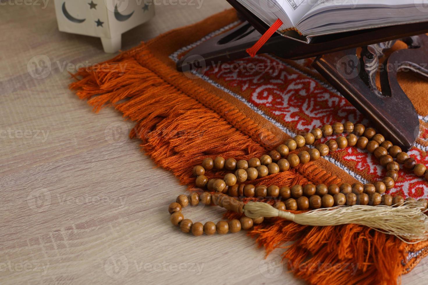 Composition of Muslim worship equipment on a wooden background photo