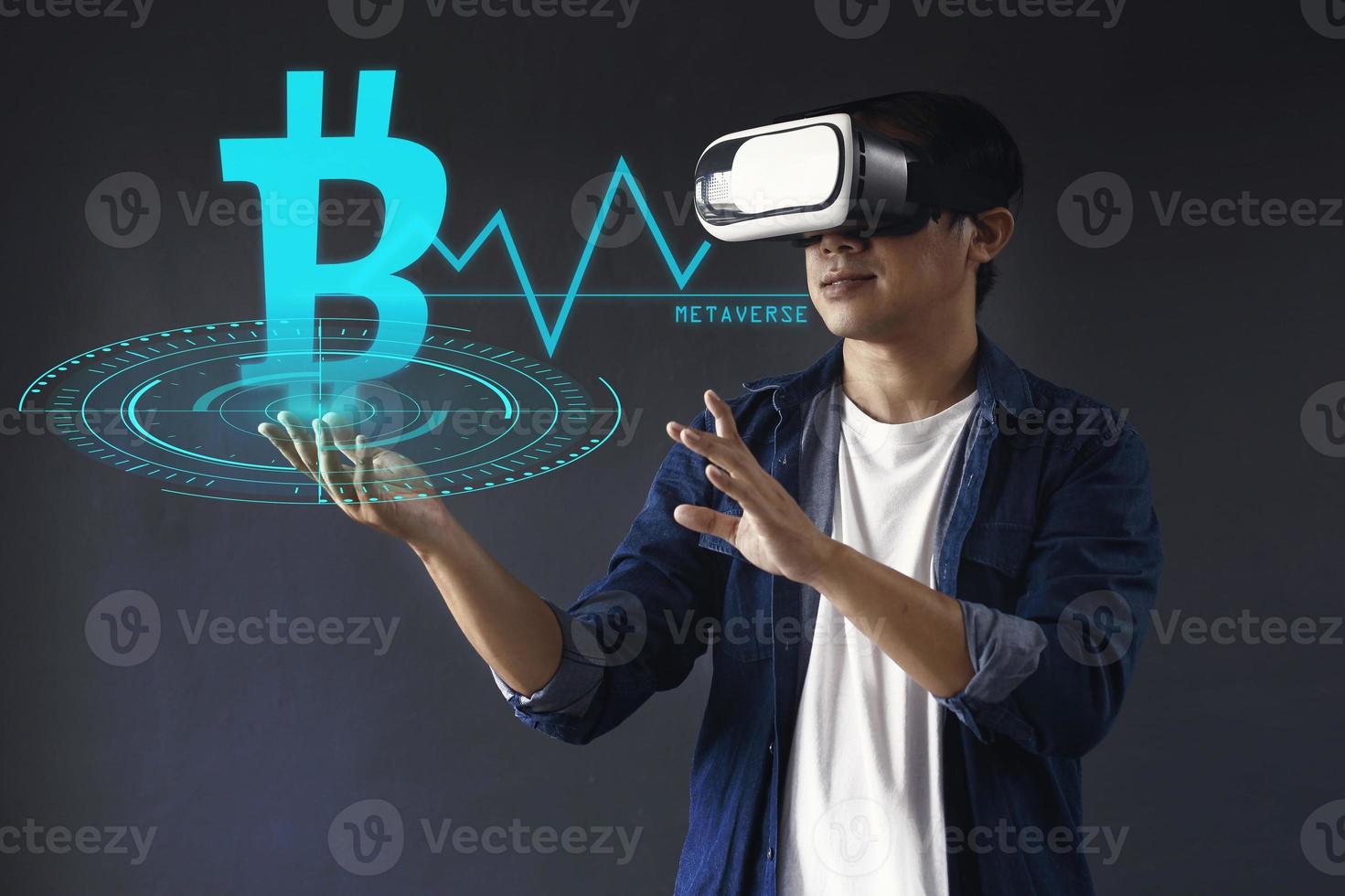 Businessman or professional trader use VR glasses touch cryptocurrency symbol ang graphic on futuristic hologram screen. Virtual trading currency concept. photo