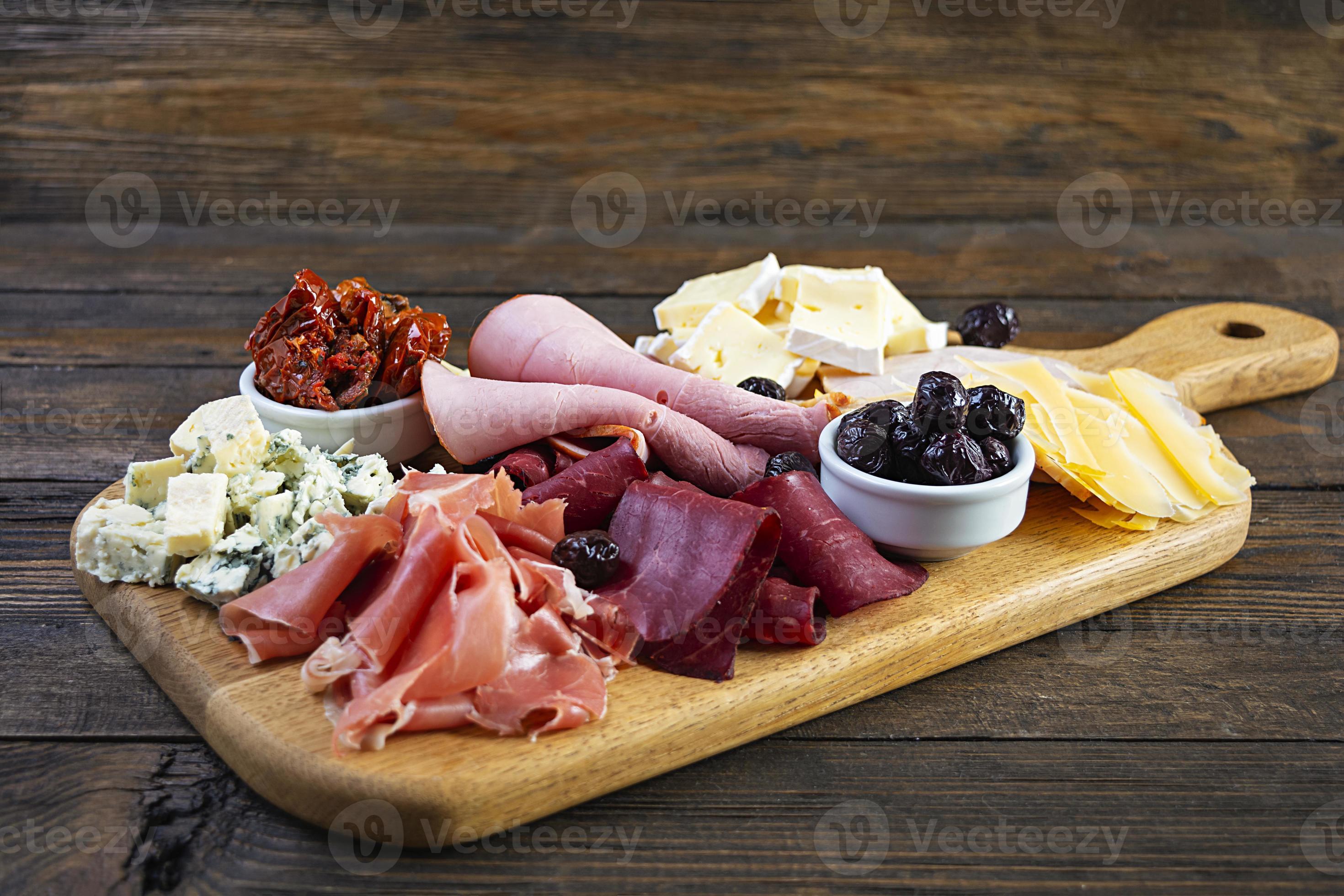 Italian antipasto. Antipasti board with ham, salsami, prosciutto, parmesan, blue cheese and