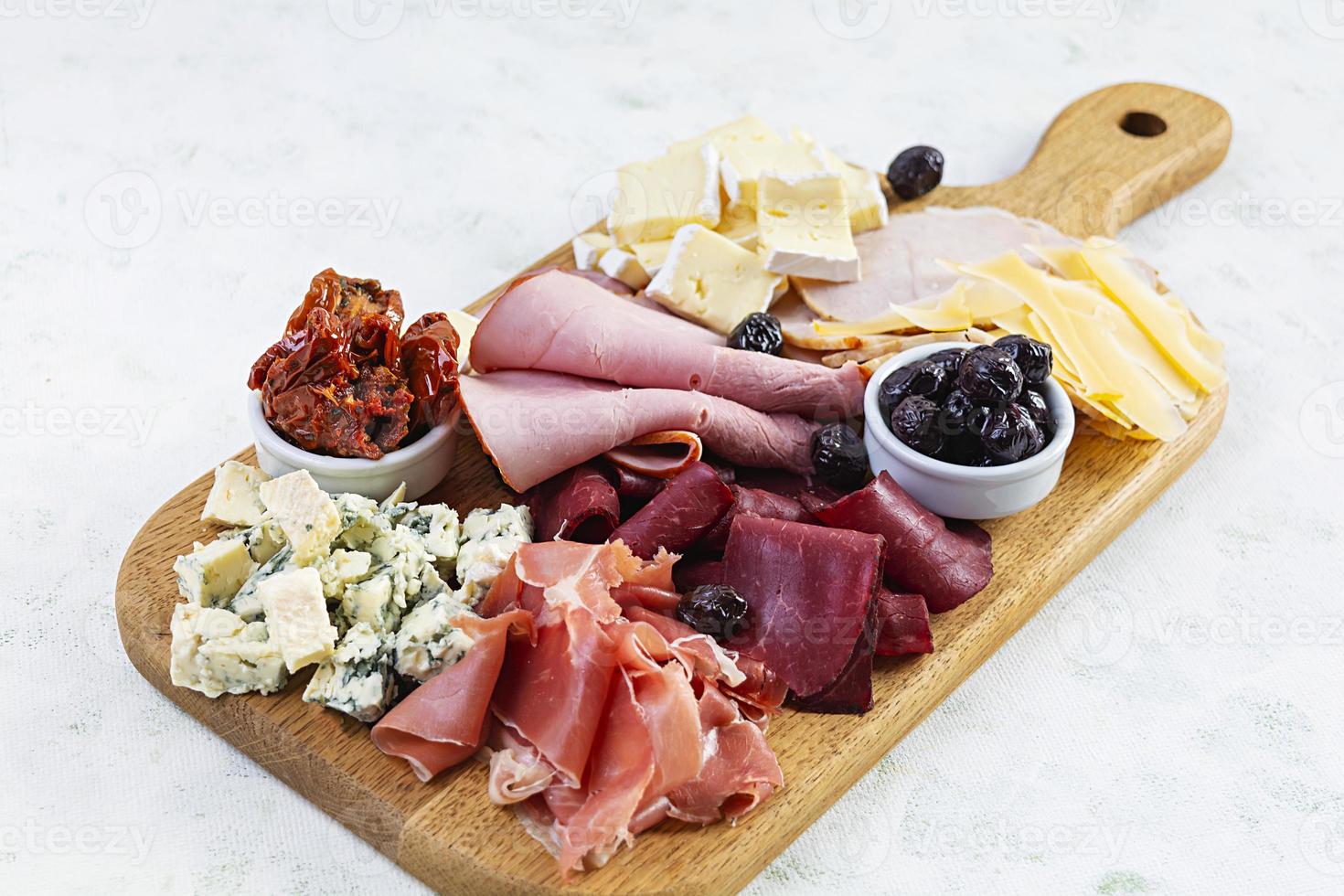 Italian antipasto. Antipasti board with ham, salsami, prosciutto