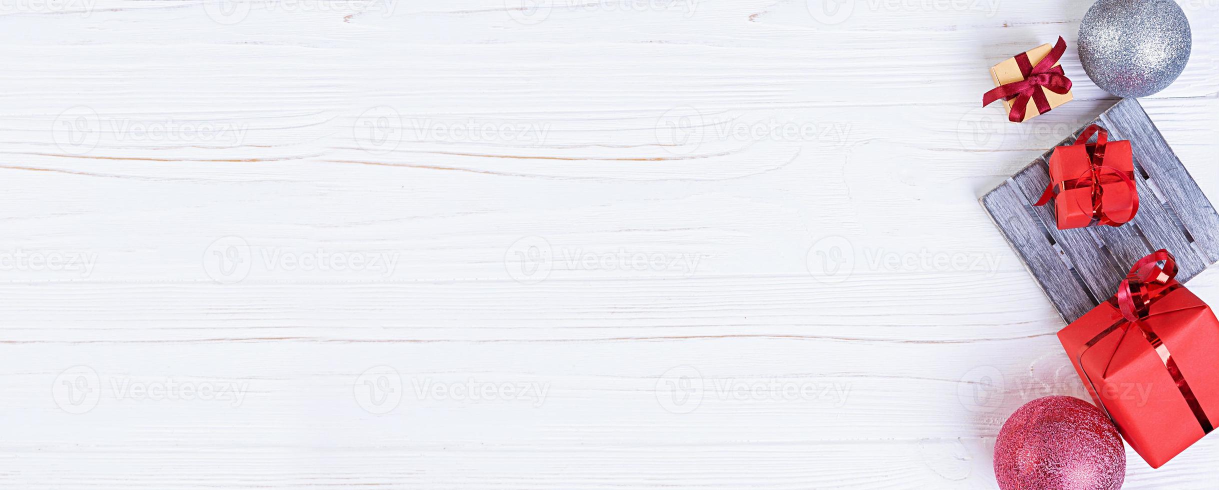 Christmas background. Christmas gift, toys, gingerbread cookies, spices and decorations on wooden background. Top view photo