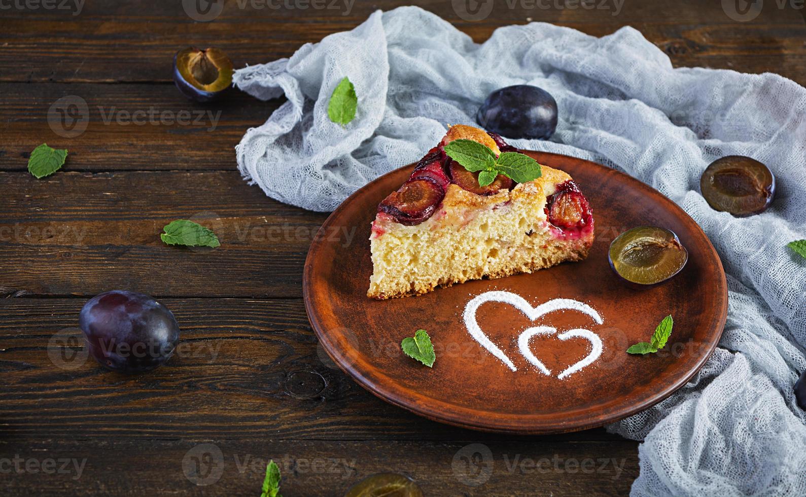 Delicious homemade plum pie on rustic background photo