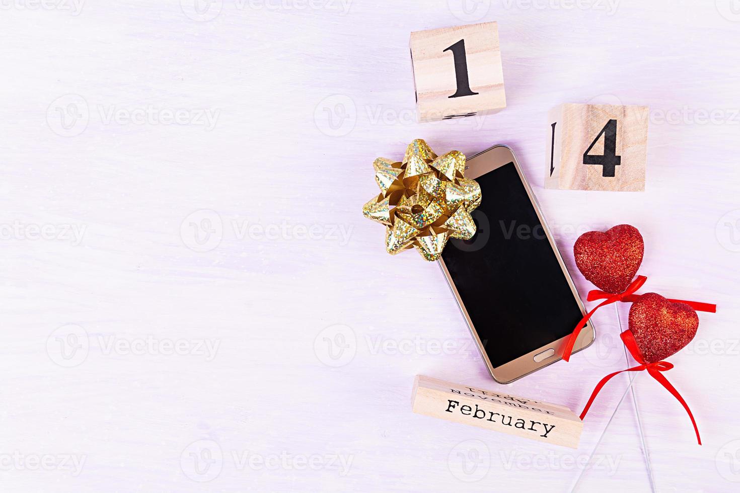 Valentine day. Wooden calendar with February 14 on it. photo