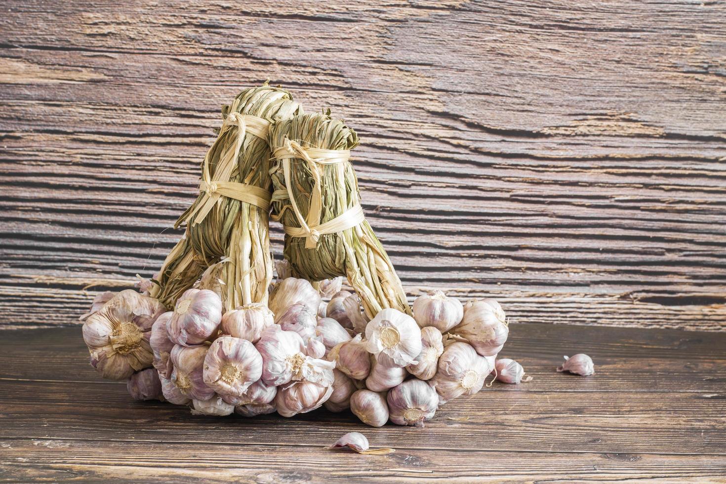 Garlic on wooden background, bunch of garlic photo