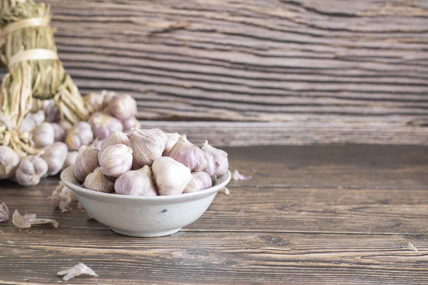 Garlic on wooden background, bunch of garlic photo