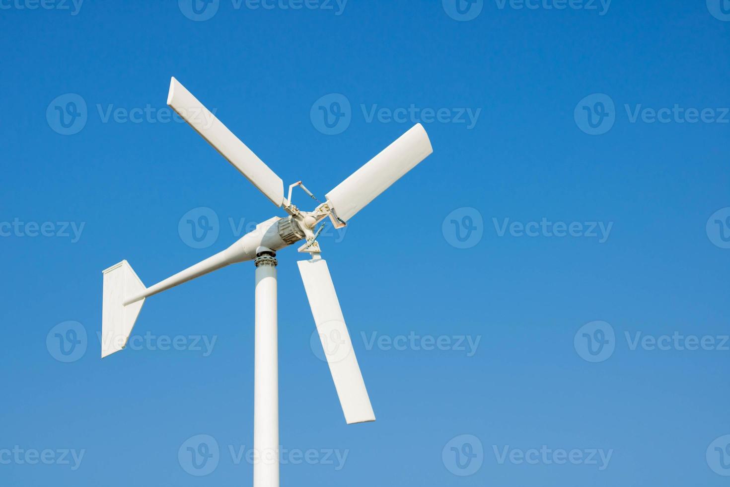 White wind turbines on a blue sky background - images photo
