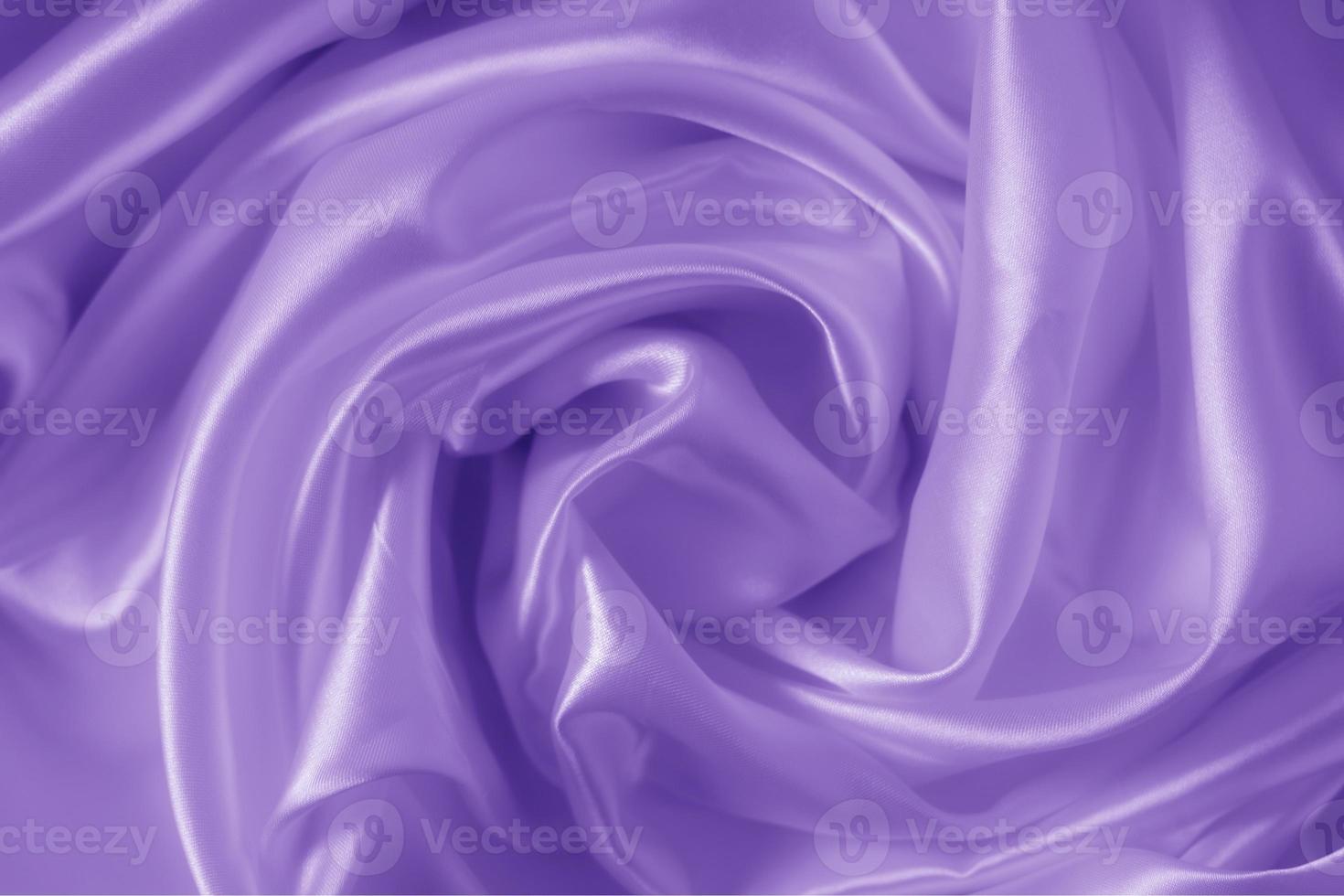 The texture of the proton purple cloth with waves and shrugs. Shiny fabric. photo