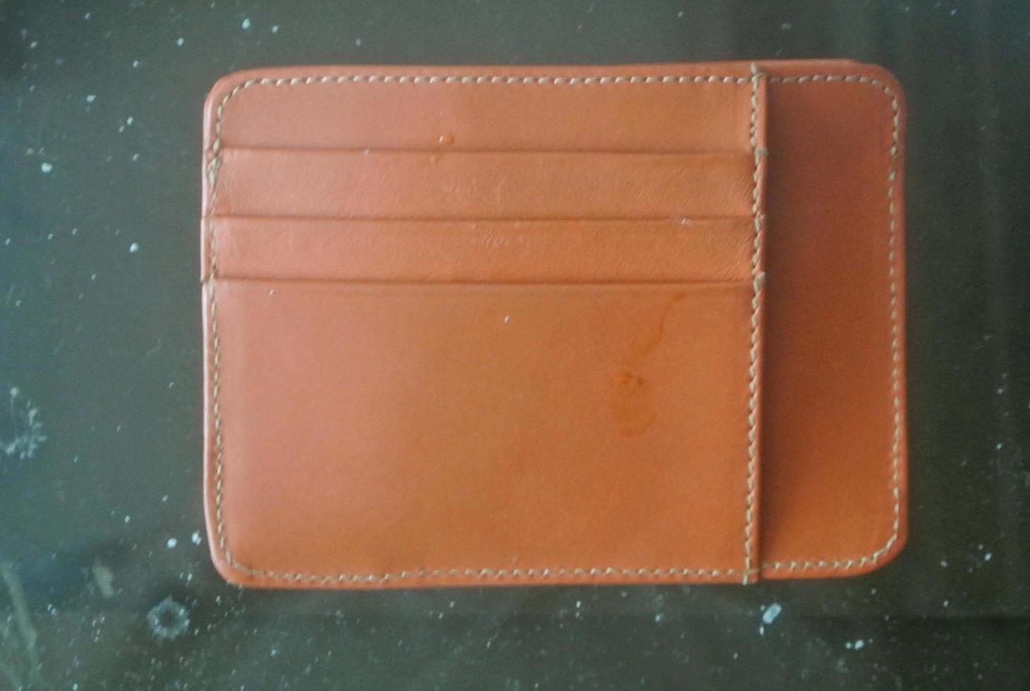 orange wallet on a table photo