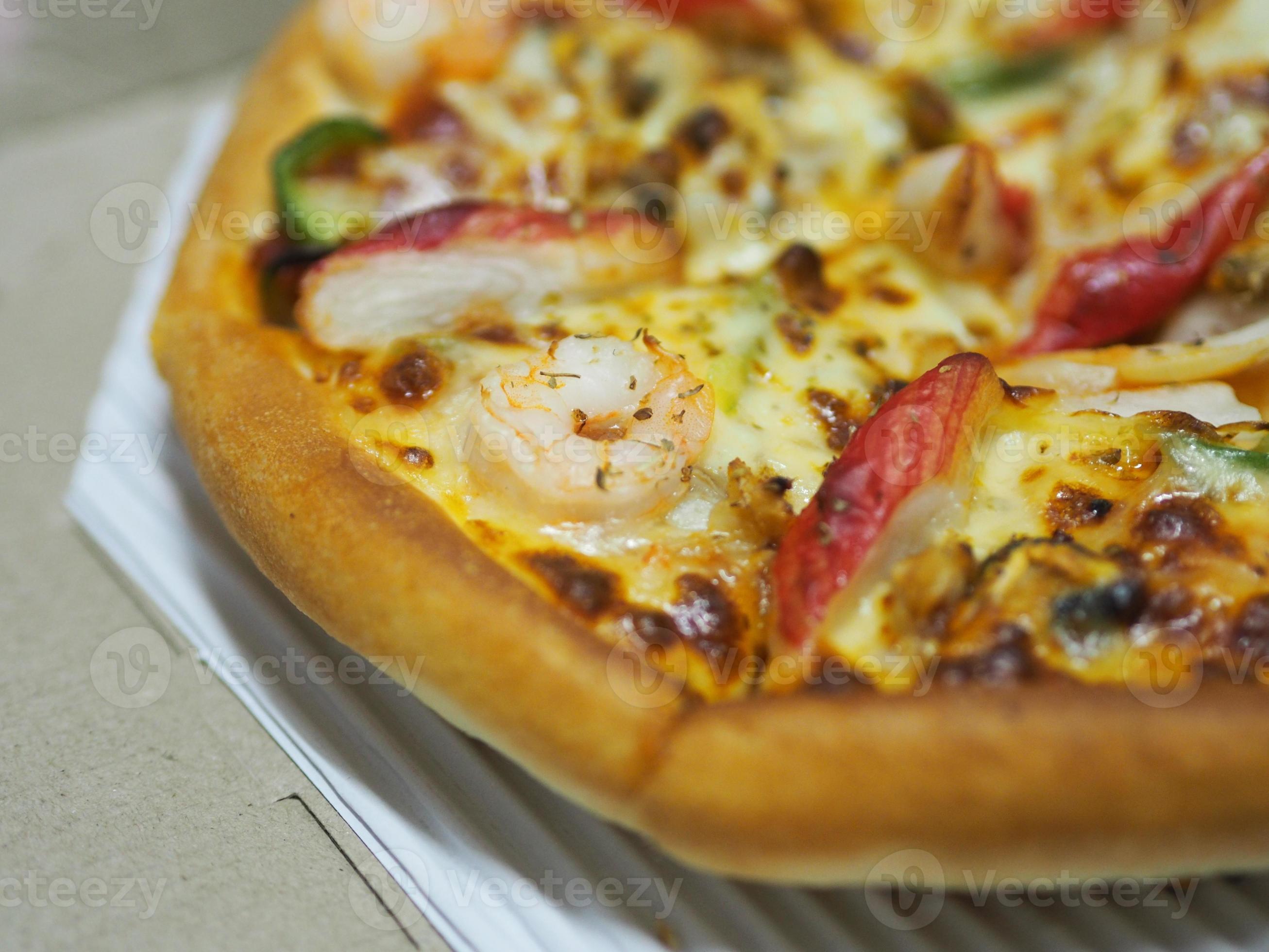 Pizza Seafood Cocktail pan on top with Shrimp, Crab Sticks, Ham, Pineapple and Sauce in paper