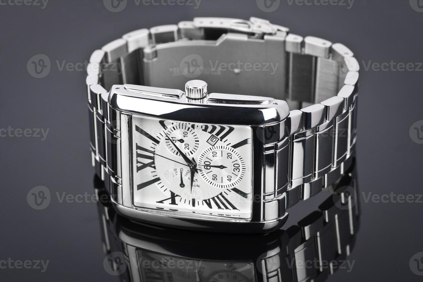 Men's wrist watch on black background. Studio shoot. photo