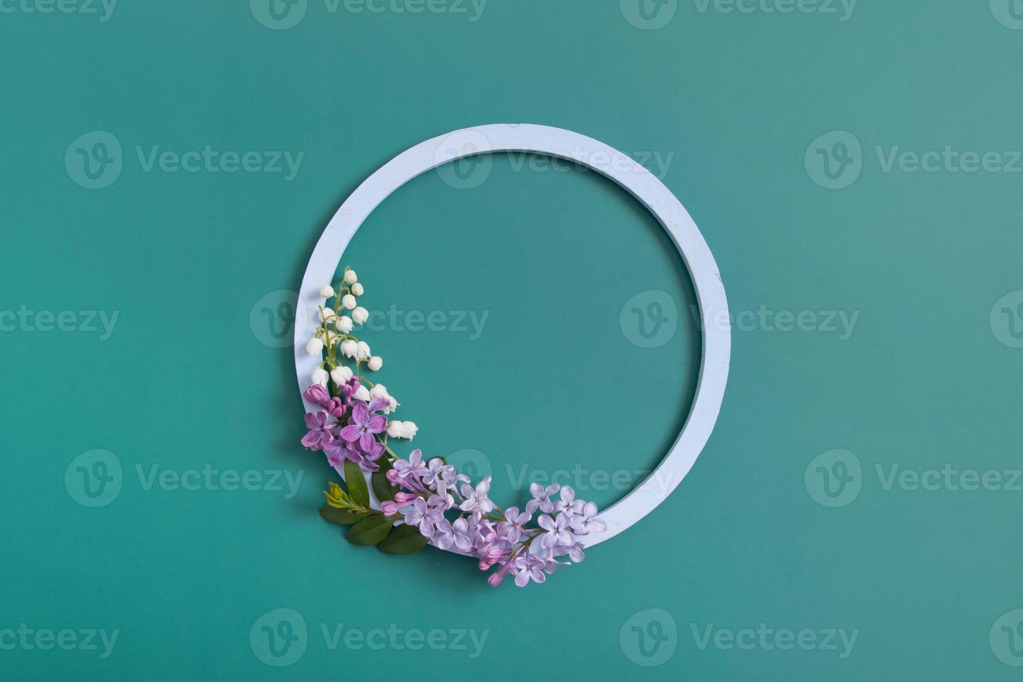 Summer or spring composition. Lily of the valley flowers with round frame copy space top view. Summer, spring floral concept photo