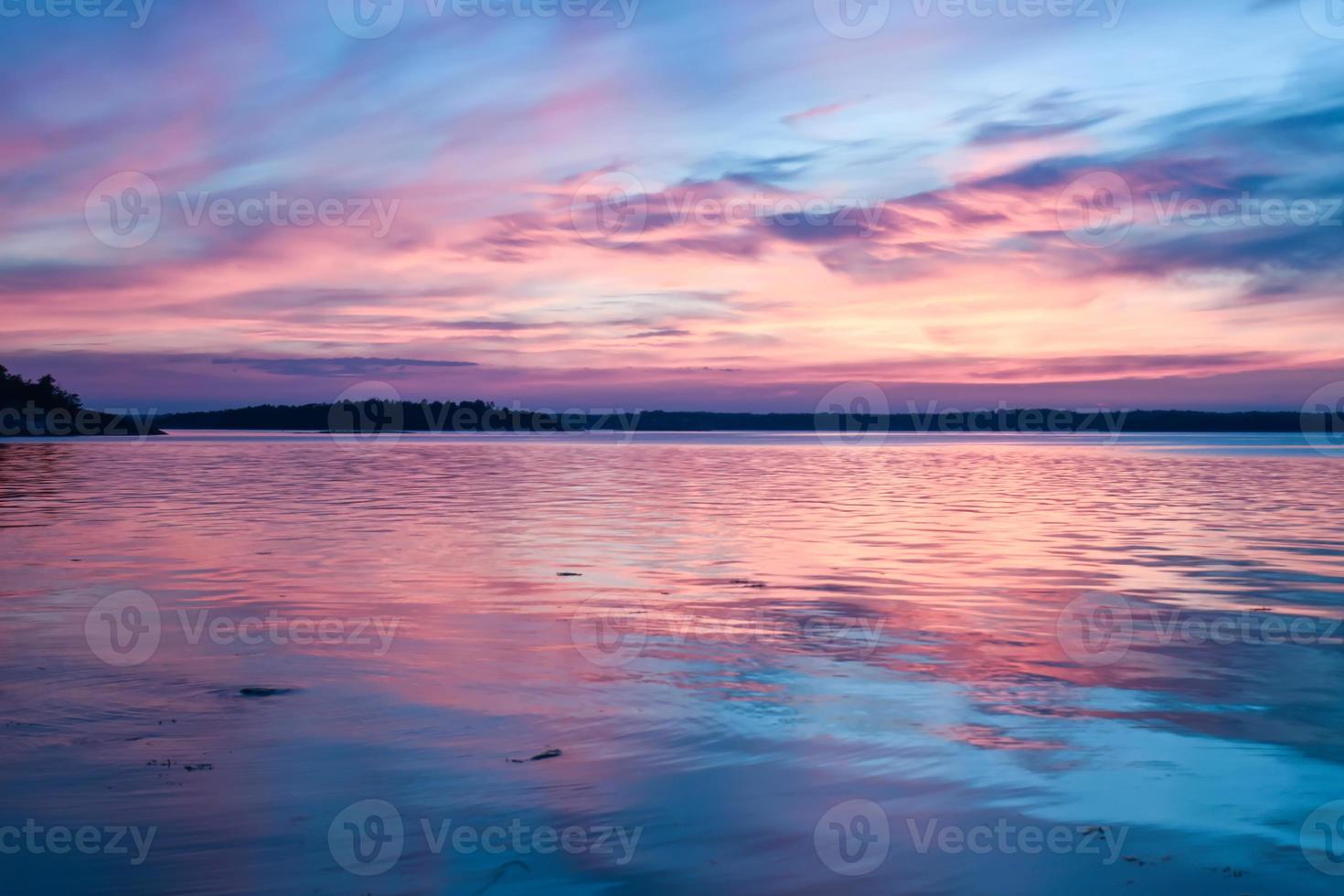 Blue pink magnificent sunset above a mirror water lake in Sweden photo