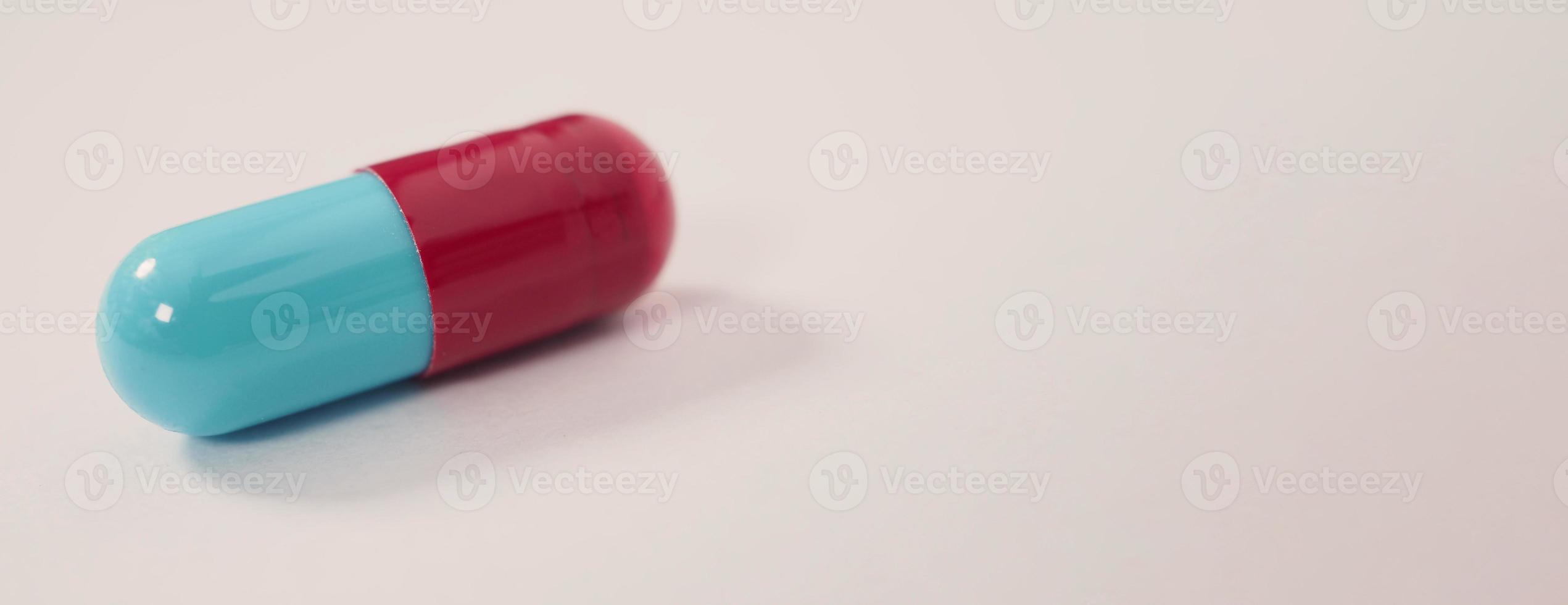 Taking or holding medication pills in hand. Capsule pill on white background. photo