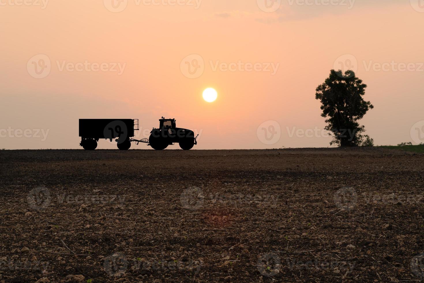 Silhouette tractor at hill farm photo