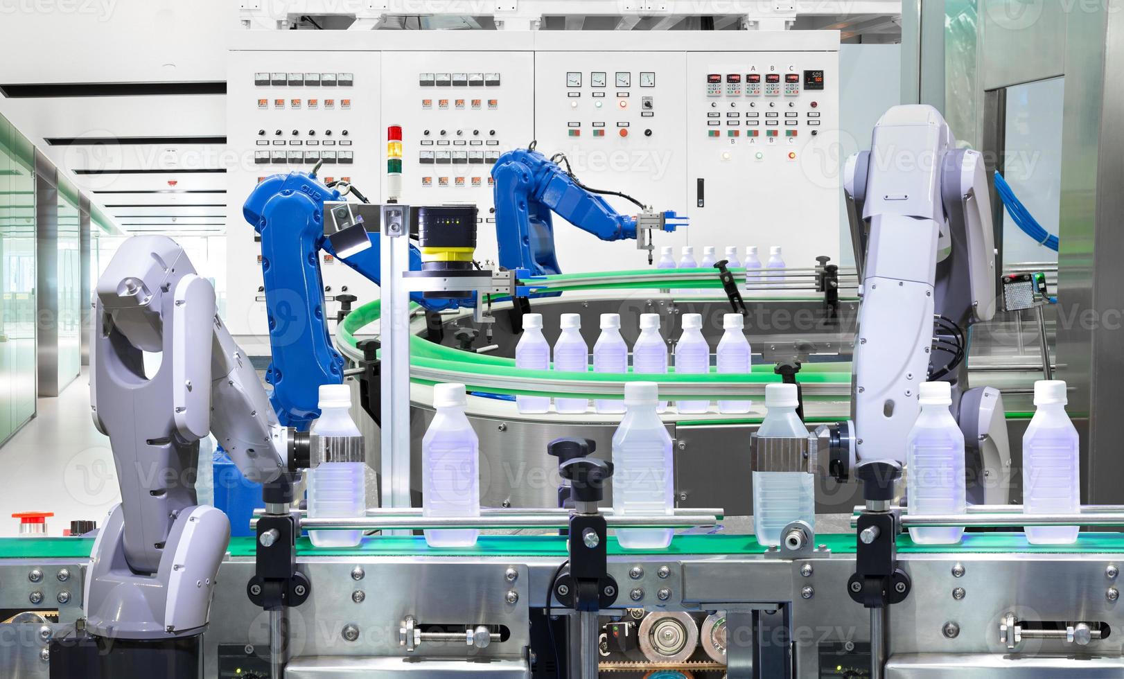 Robotic arm holding water bottles on production line in factory, Industry 4.0 concept photo