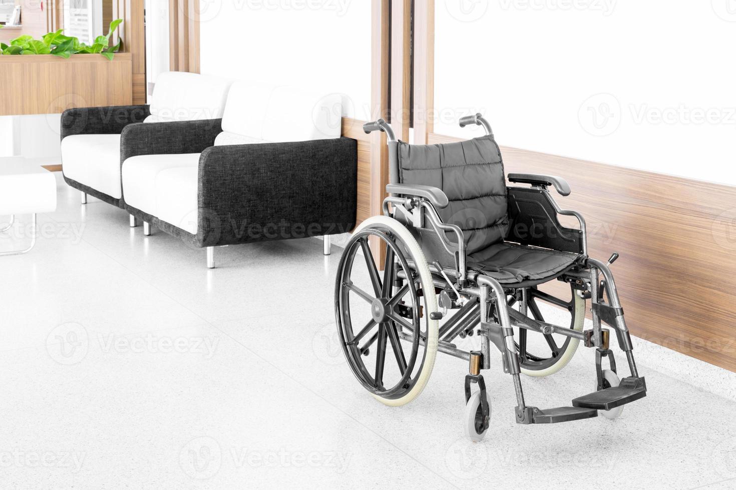 Empty wheelchair parked in hospital hallway photo