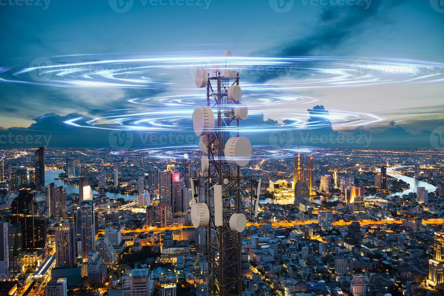 Telecommunication tower with 5G cellular network antenna wave on night city background photo