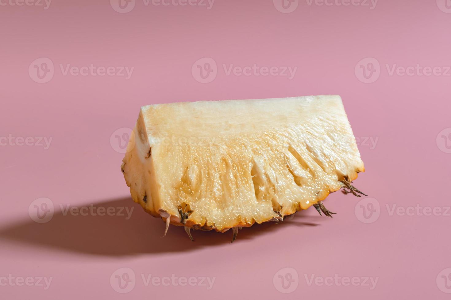Minimal healthy food pineapple sliced on pink table. photo