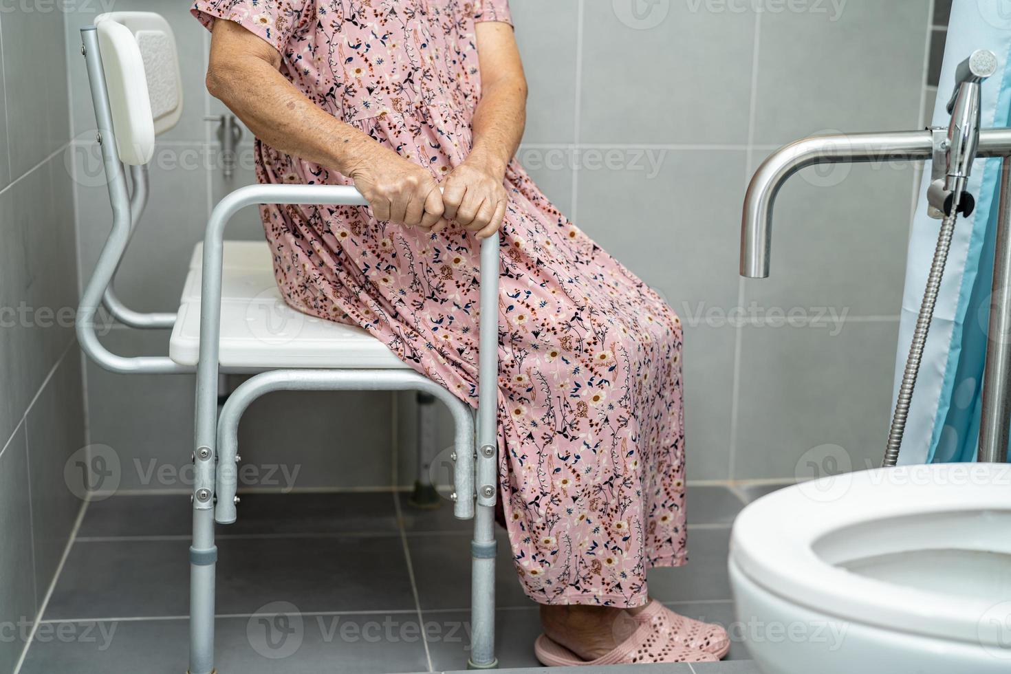 Asian senior or elderly old lady woman patient use toilet bathroom handle security in nursing hospital ward, healthy strong medical concept. photo