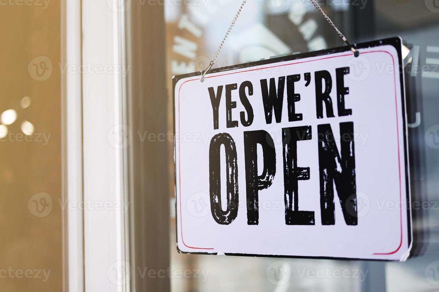 close up photo of signboard yeas we are open on door on blur background. cafe, salon, restaurant ready to work. promotion business concept.