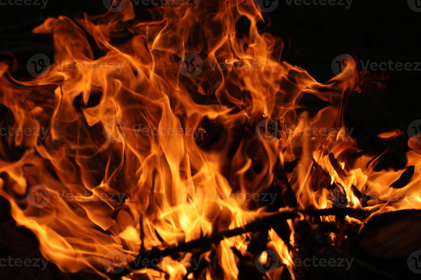 Fire flames on black background. The fire in the natural forest, flames and sparks on a dark background Fuel , lights on a black background. photo