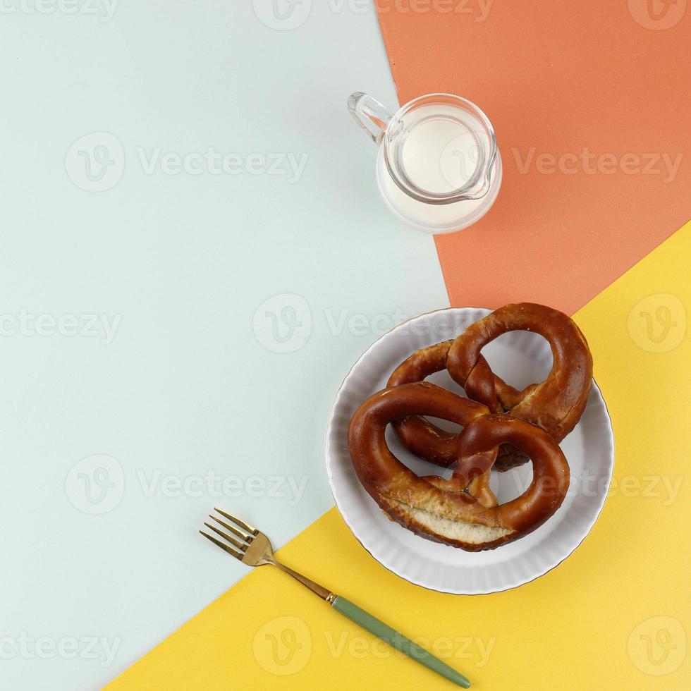 Top View Freshly Baked Homemade Soft Pretzel with Salt on Colorful Table. photo