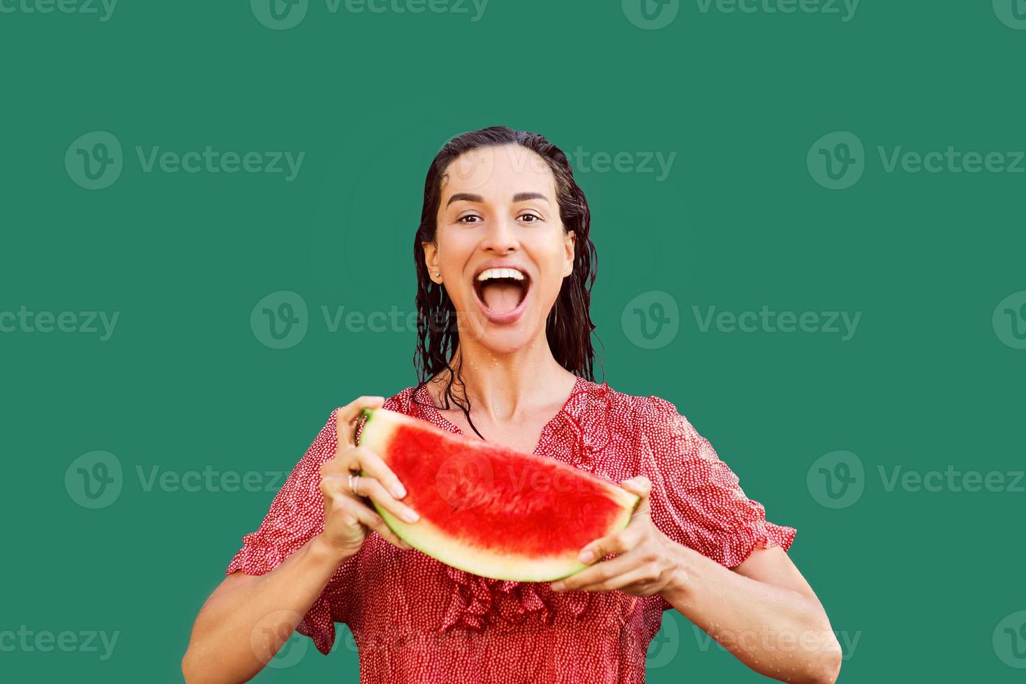 Cheerful woman holding a piece of sliced watermelon. Summer concept photo