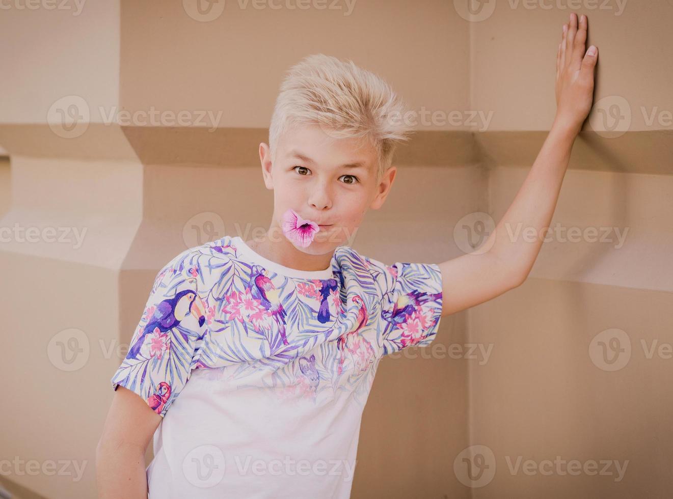 caucasian boy smelling flower photo