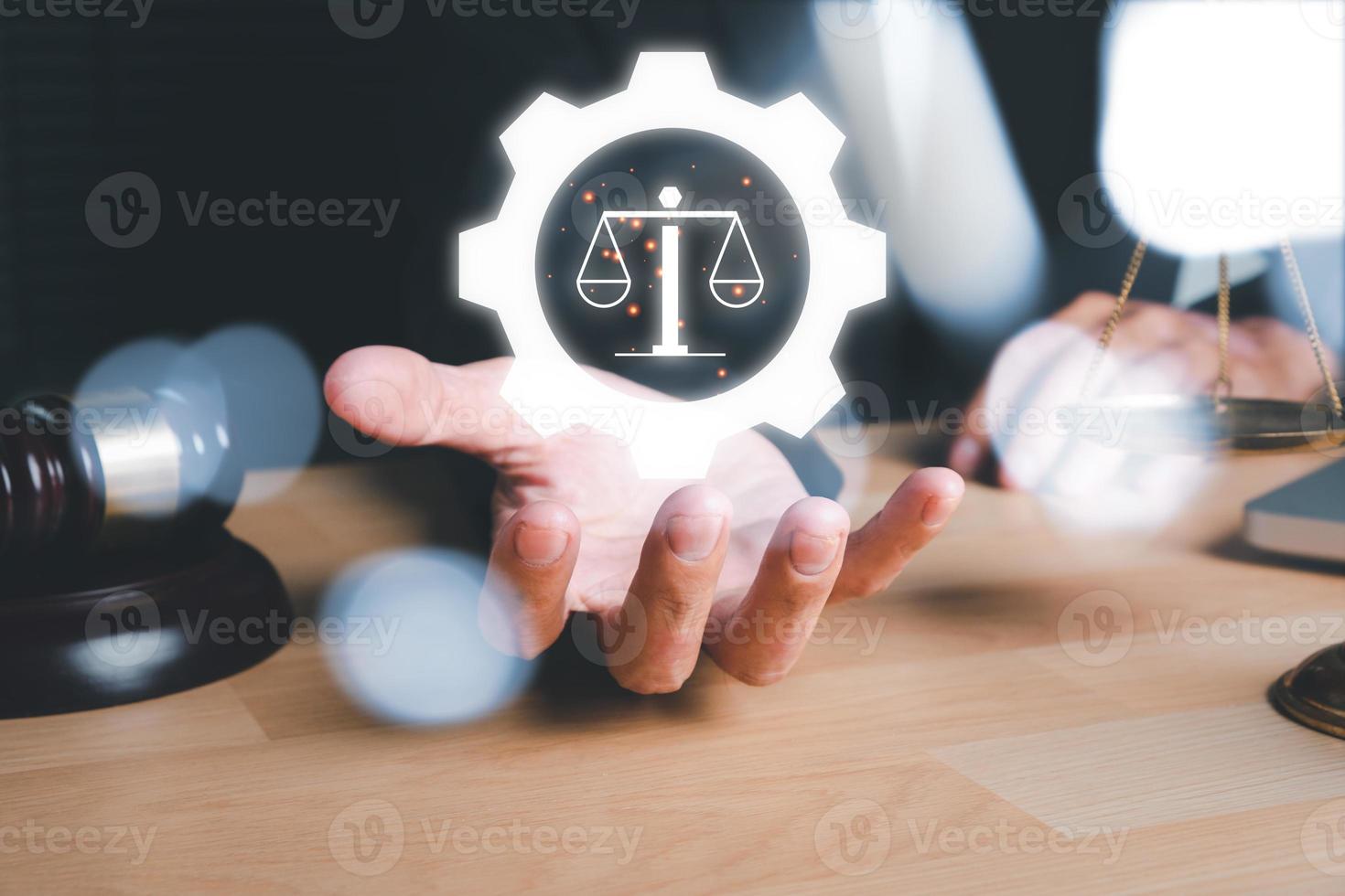 Male lawyer hand holding holographic law icon on office desk, terrorism, crime, judgment, verdict, justice and law concept photo
