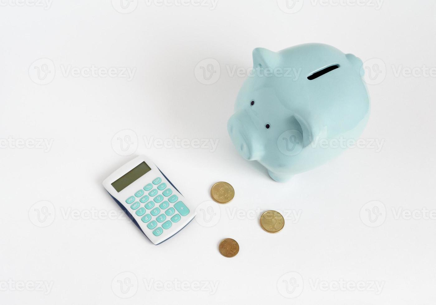 Illustration of counting money. Blue piggy bank with calculator and coins on white background photo