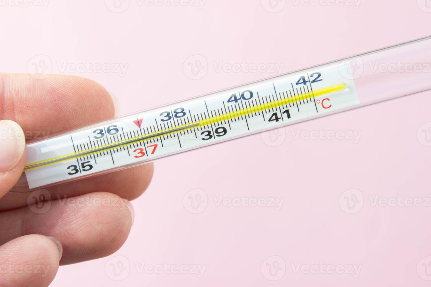 https://static.vecteezy.com/system/resources/previews/008/091/686/non_2x/mercury-thermometer-in-hand-on-pink-background-close-up-thermometer-shows-a-temperature-of-38-7-degrees-celsius-photo.jpg