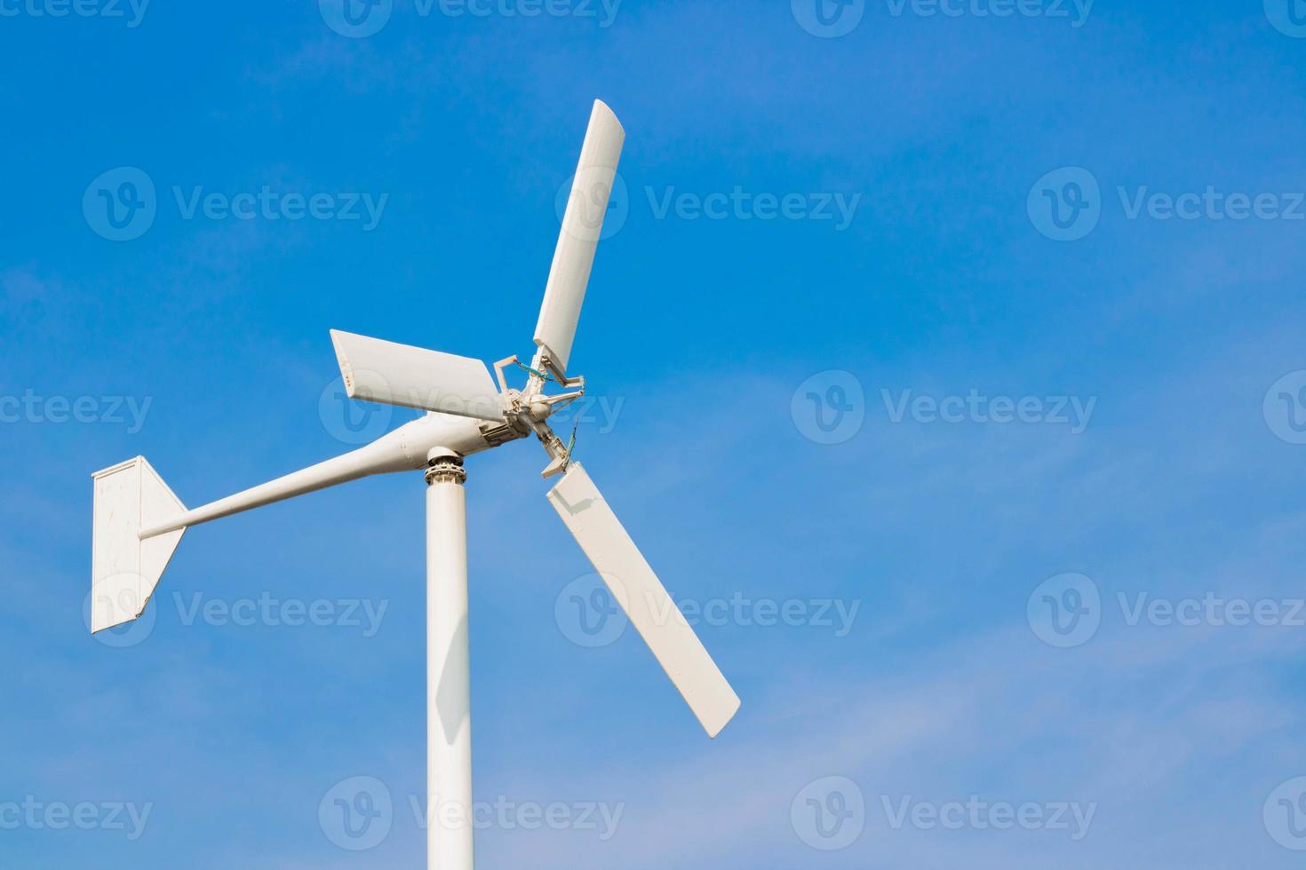 White wind turbines on a blue sky background - images photo