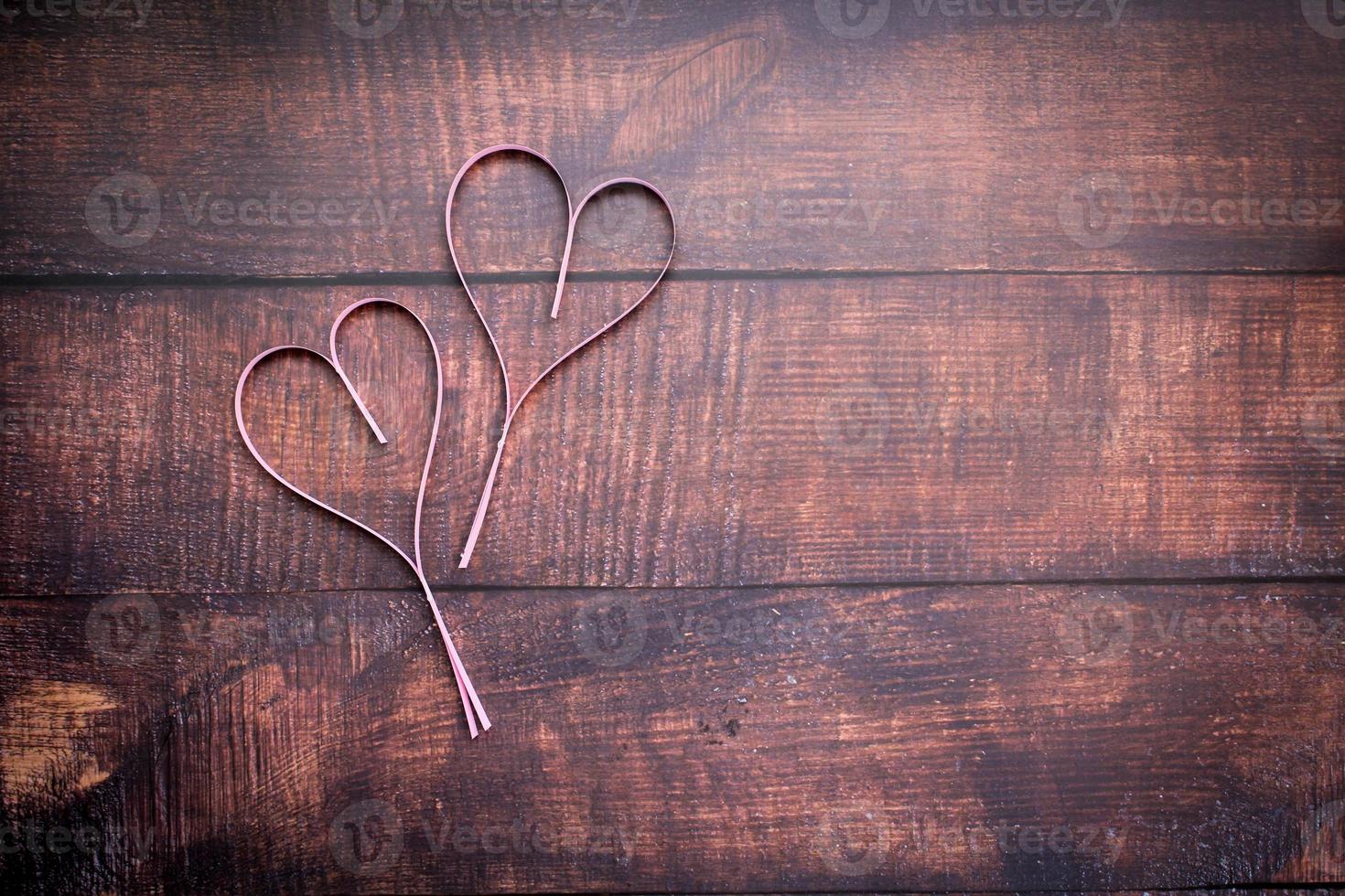 Paper heart on wooden floor photo