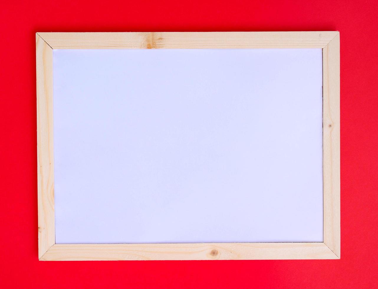 Blank frame on red background for interior design and Christmas concepts. photo