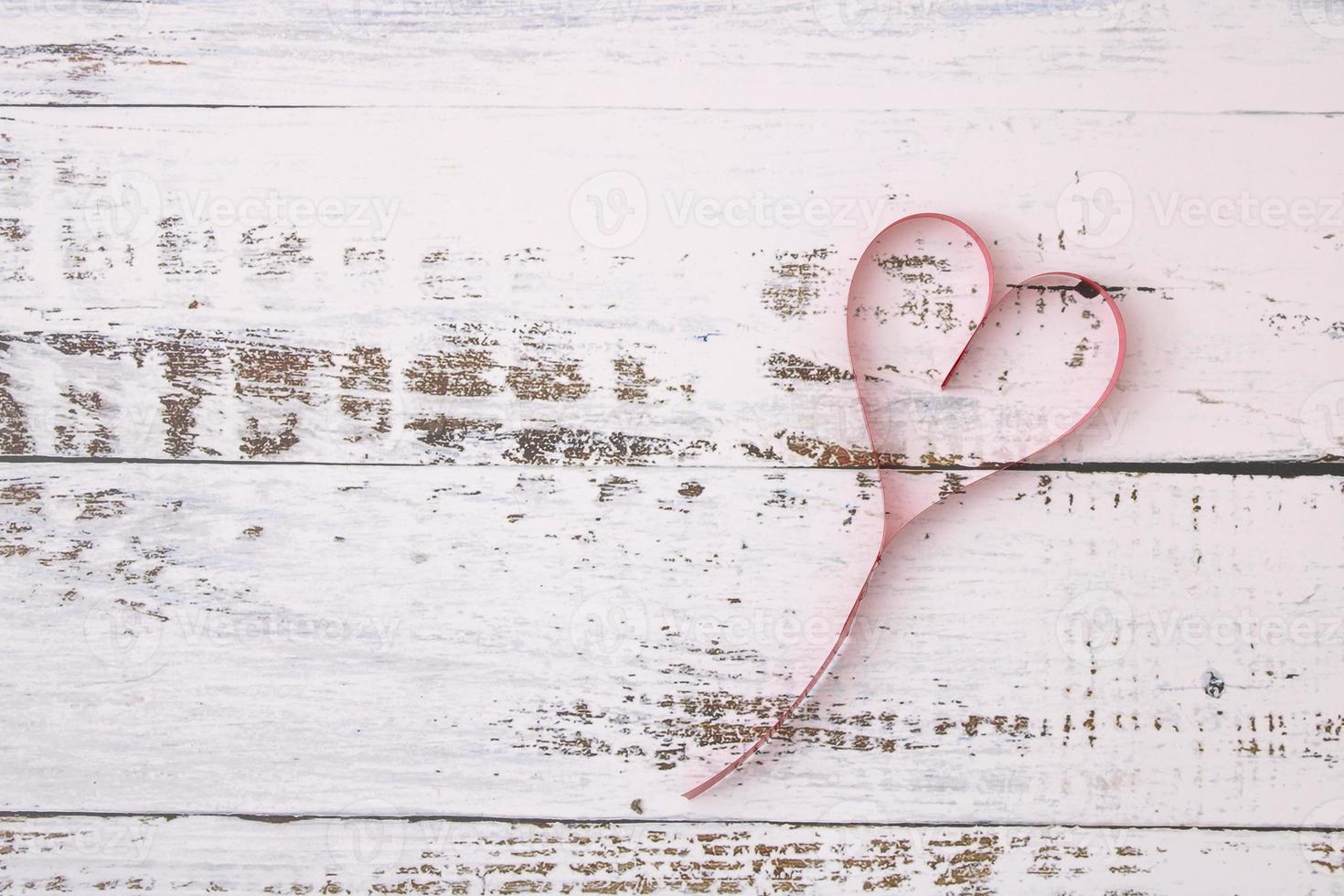 Red heart-shaped ribbons on wooden floors photo