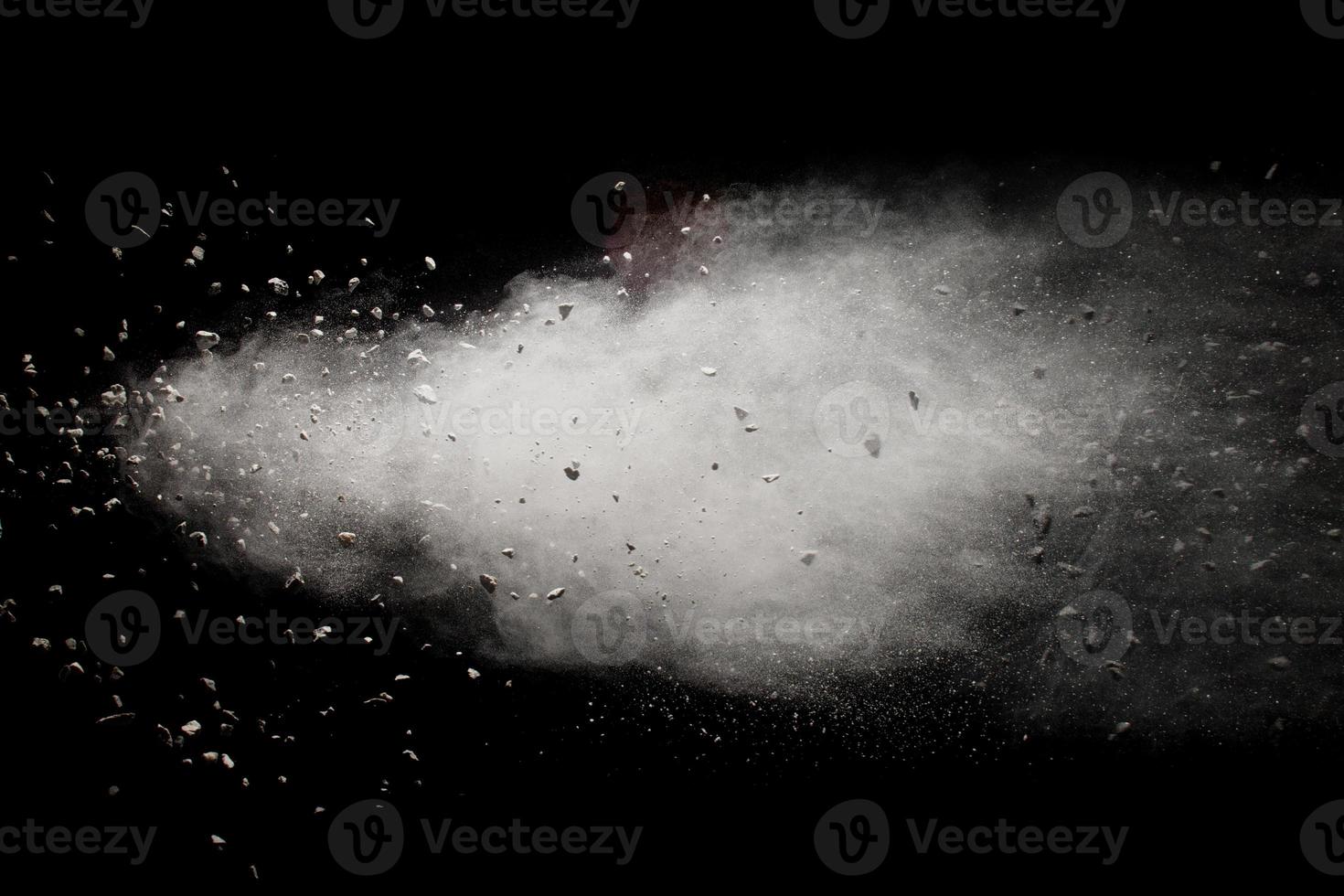 Launched white dust particles splashing. photo