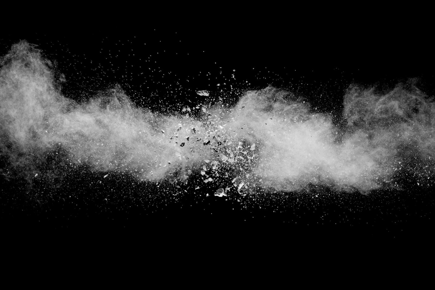 White powder explosion against dark background. photo