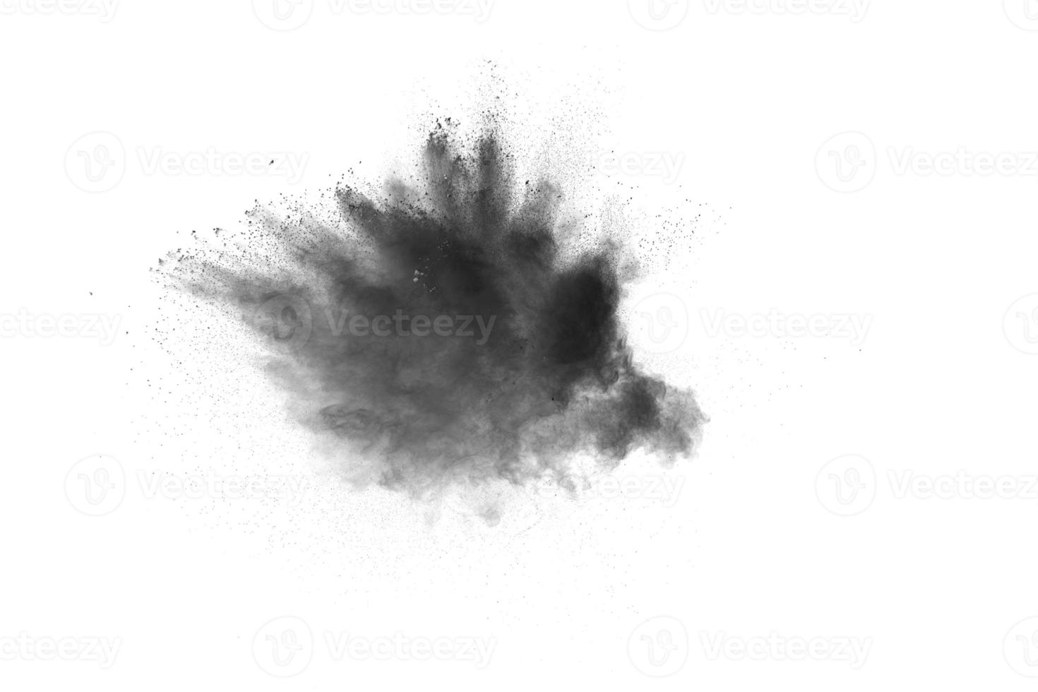 Black powder explosion. The particles of charcoal splatter on white background. Closeup of black dust particles splash isolated on  background. photo