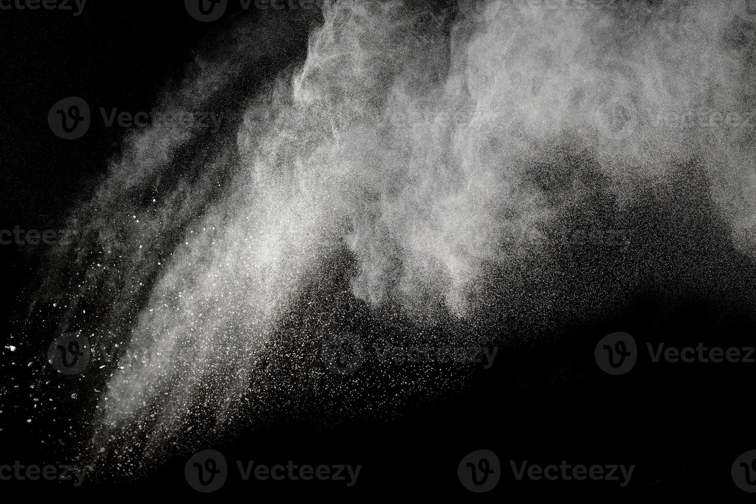 Launched white dust particles splashing. photo