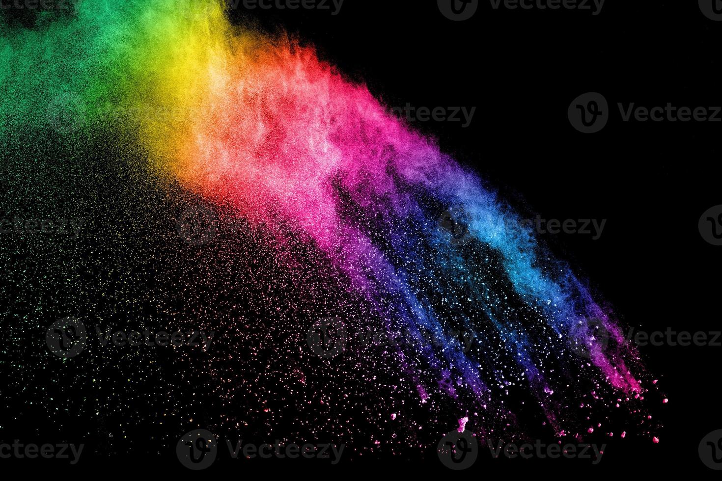 Abstract multicolored powder explosion on black background. Red and blue dust particles splattered on background. photo