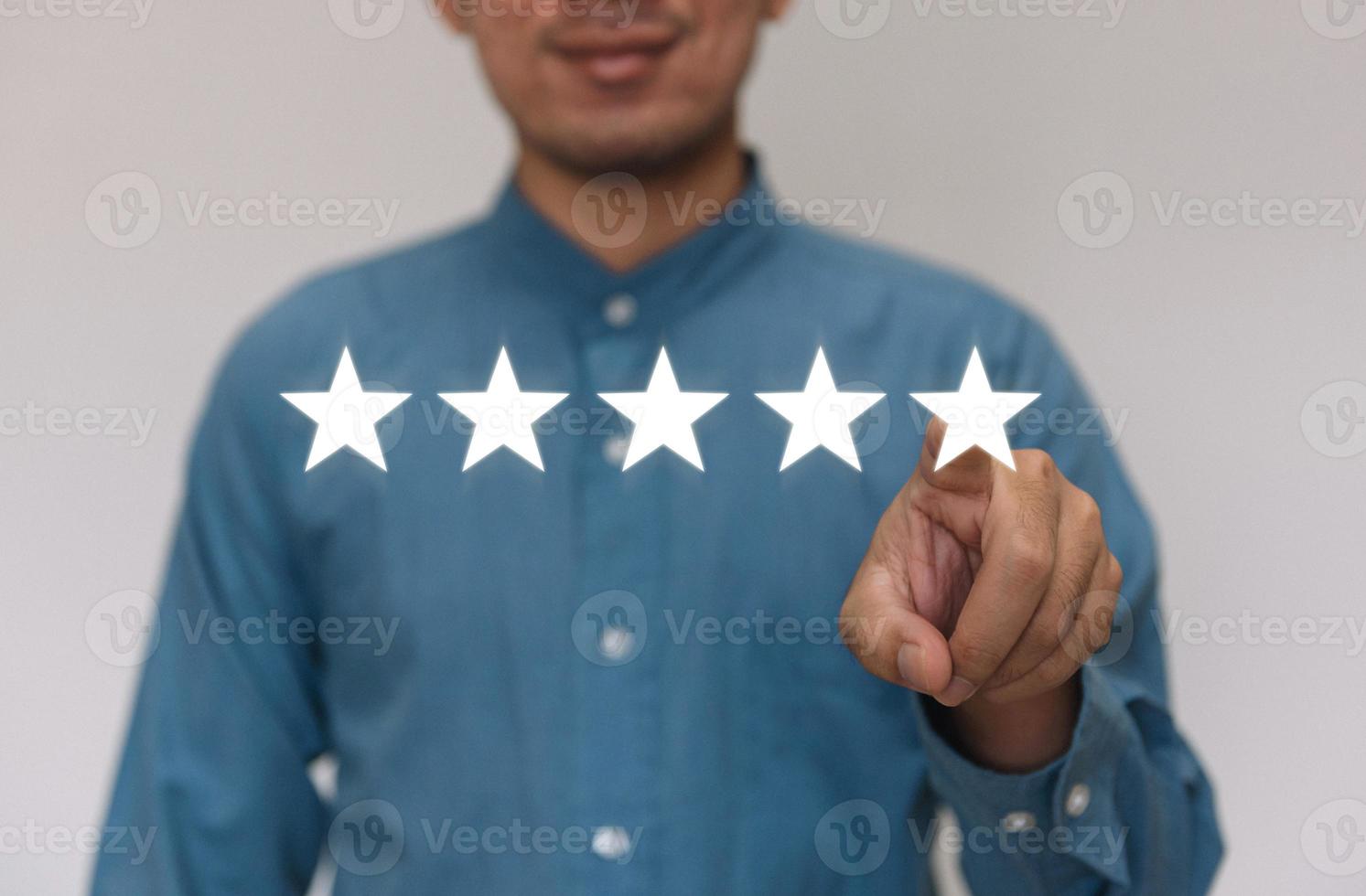 Businessmen wearing a light blue shirt to selecting the level of satisfaction score icons with copy space. Customer service experience and business satisfaction survey concept photo