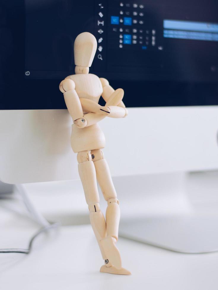 Wooden Man Lonely figure sitting alone photo