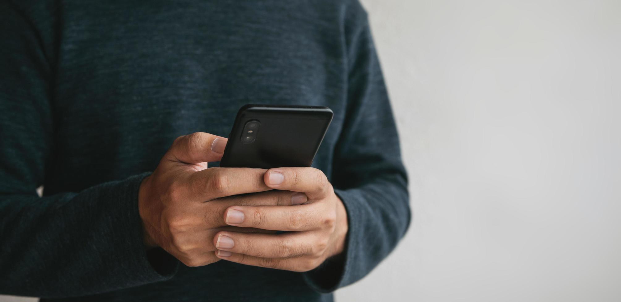 Man using cellphone for searching data and social media on internet. photo