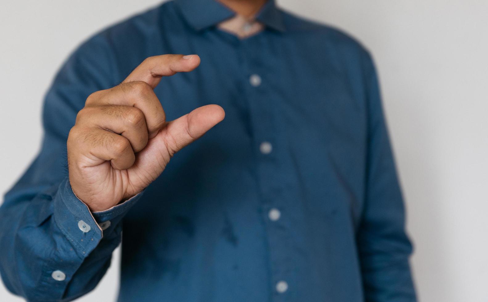 Young handsome man wearing light blue shirt with different behaviors at work photo
