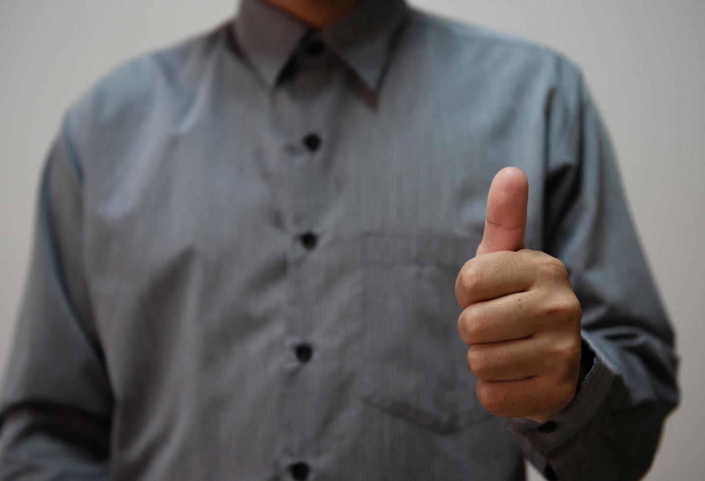 Young handsome man wearing light blue shirt with different behaviors at work photo