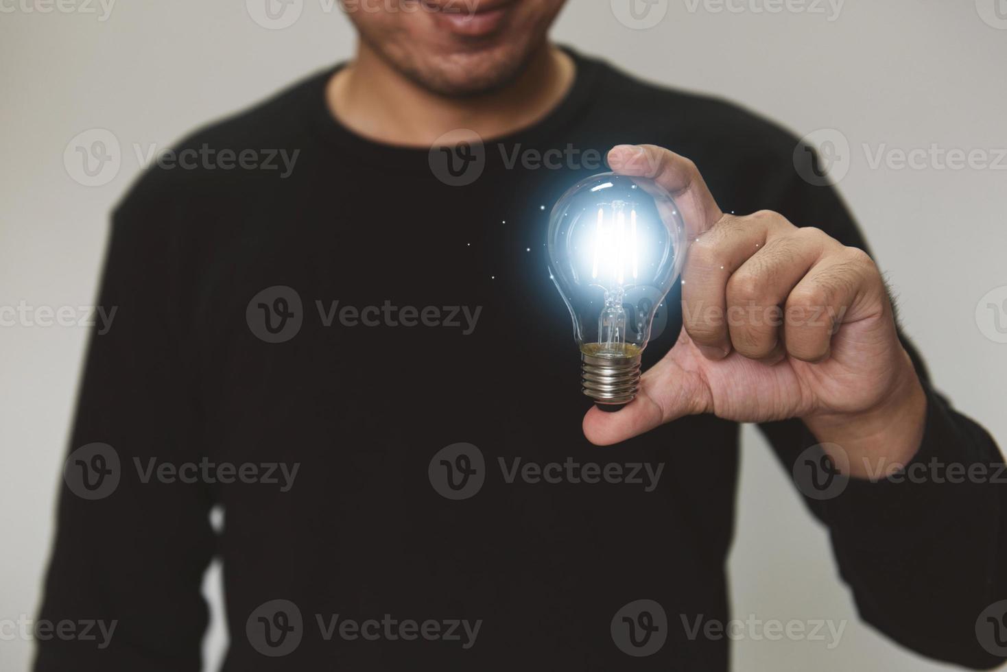 Hand holding light bulb. idea with innovation and inspiration.  innovative technology and solution creative business design concept. photo