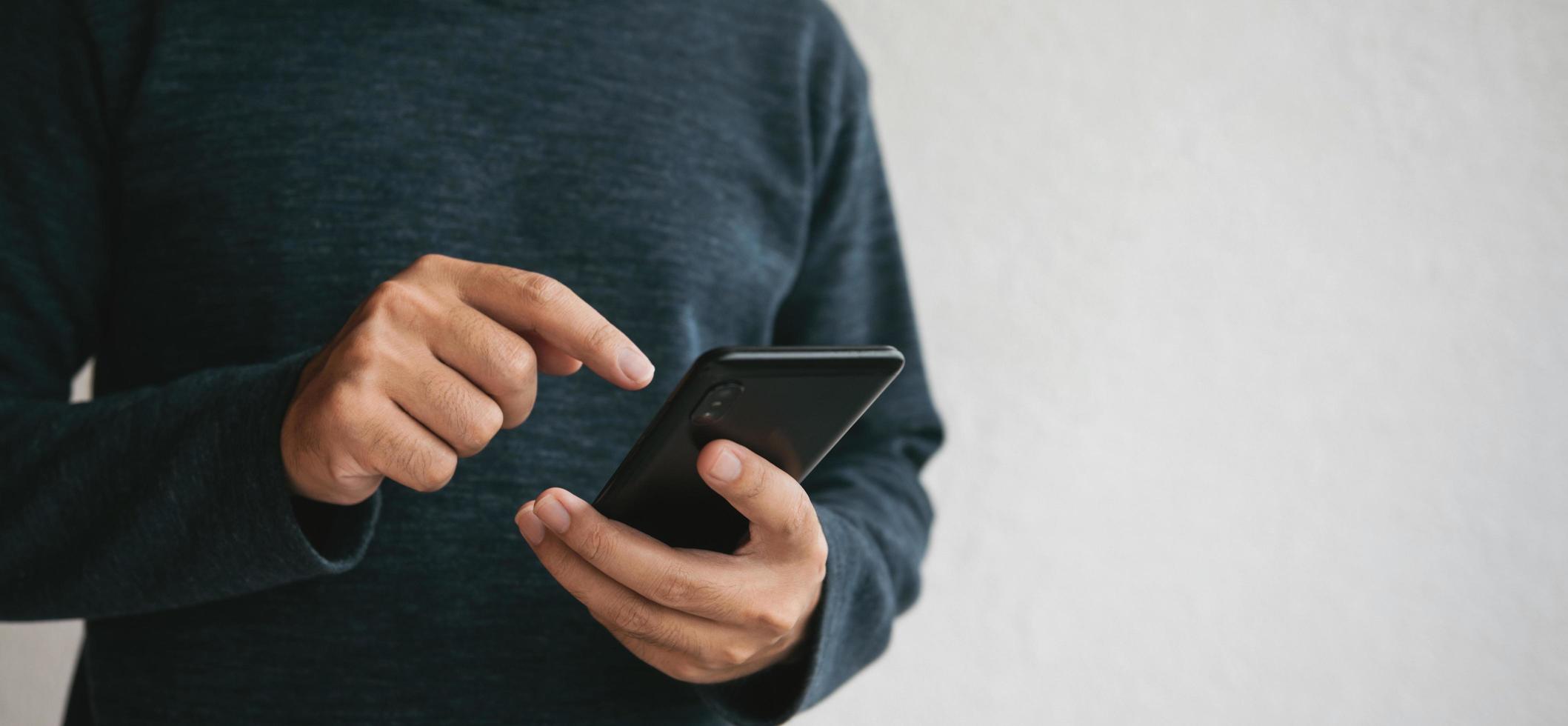 Man using cellphone for searching data and social media on internet. photo