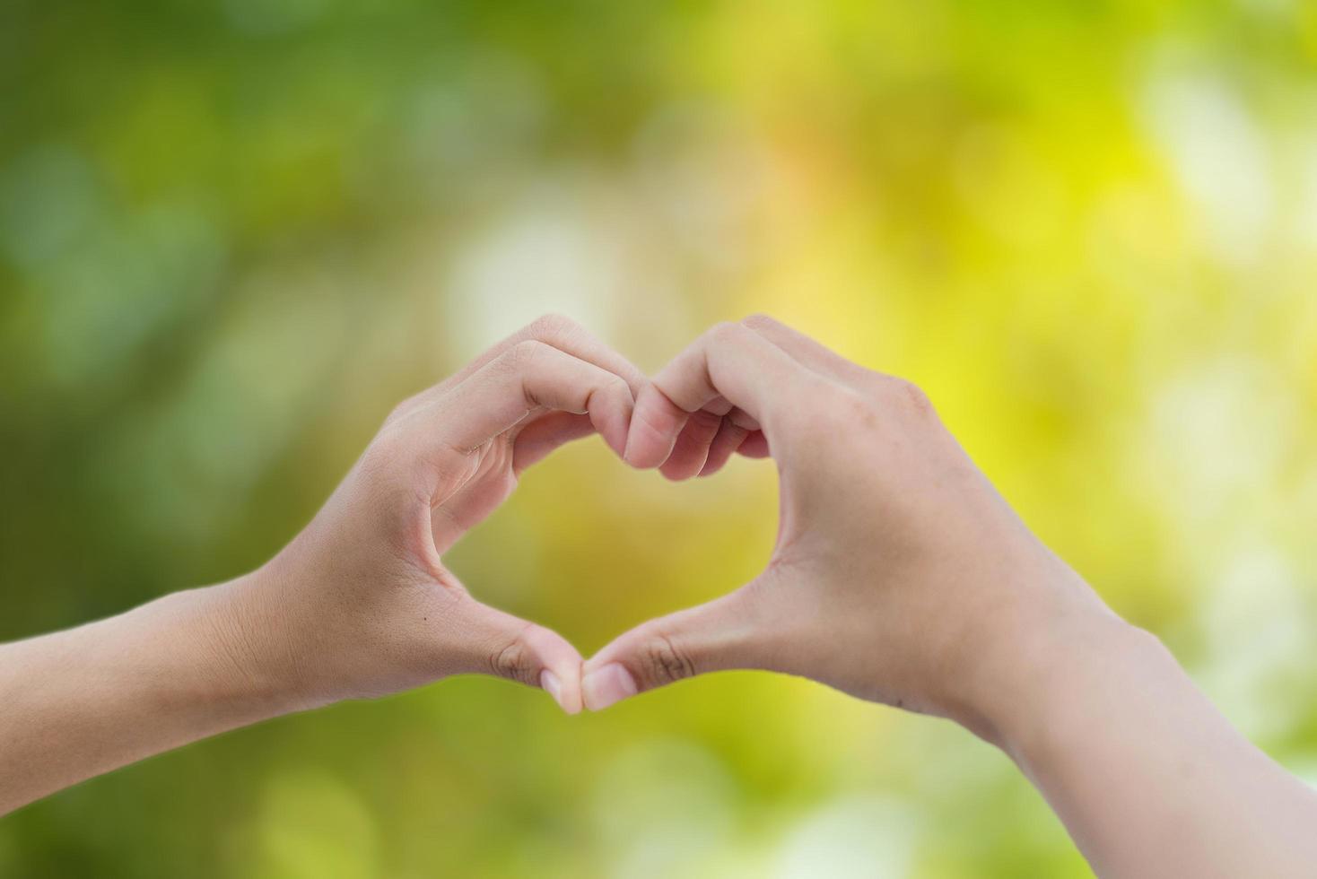 hand of love on green bokeh background photo
